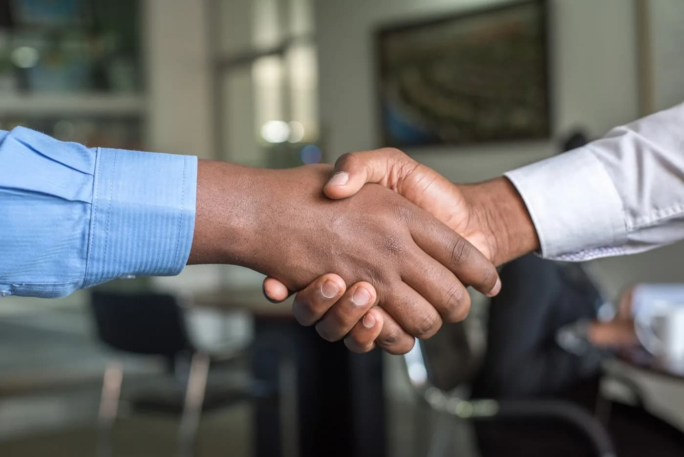Web2PrintSolution support team member shaking hands with a print shop customer
